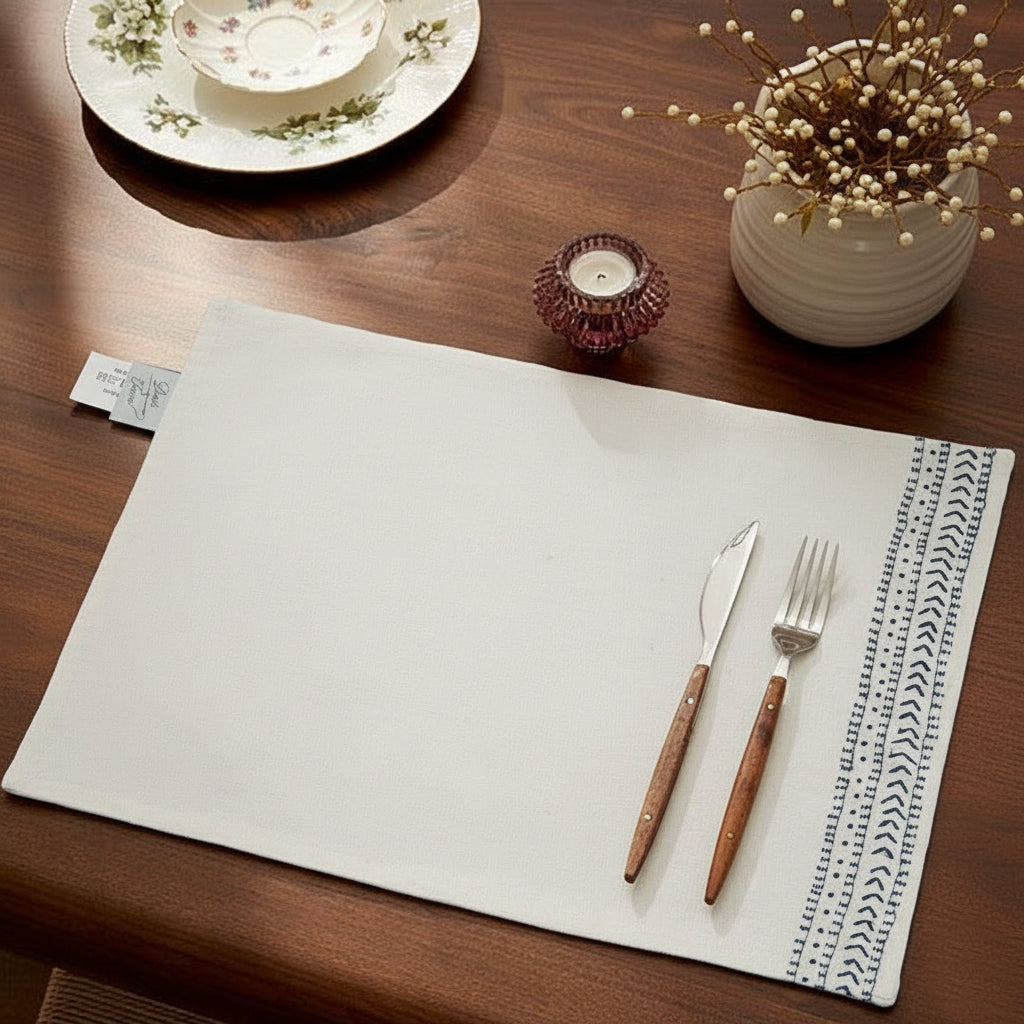 Off White cotton casement placemat with indigo running stitch on one side, inspired by Inca motifs